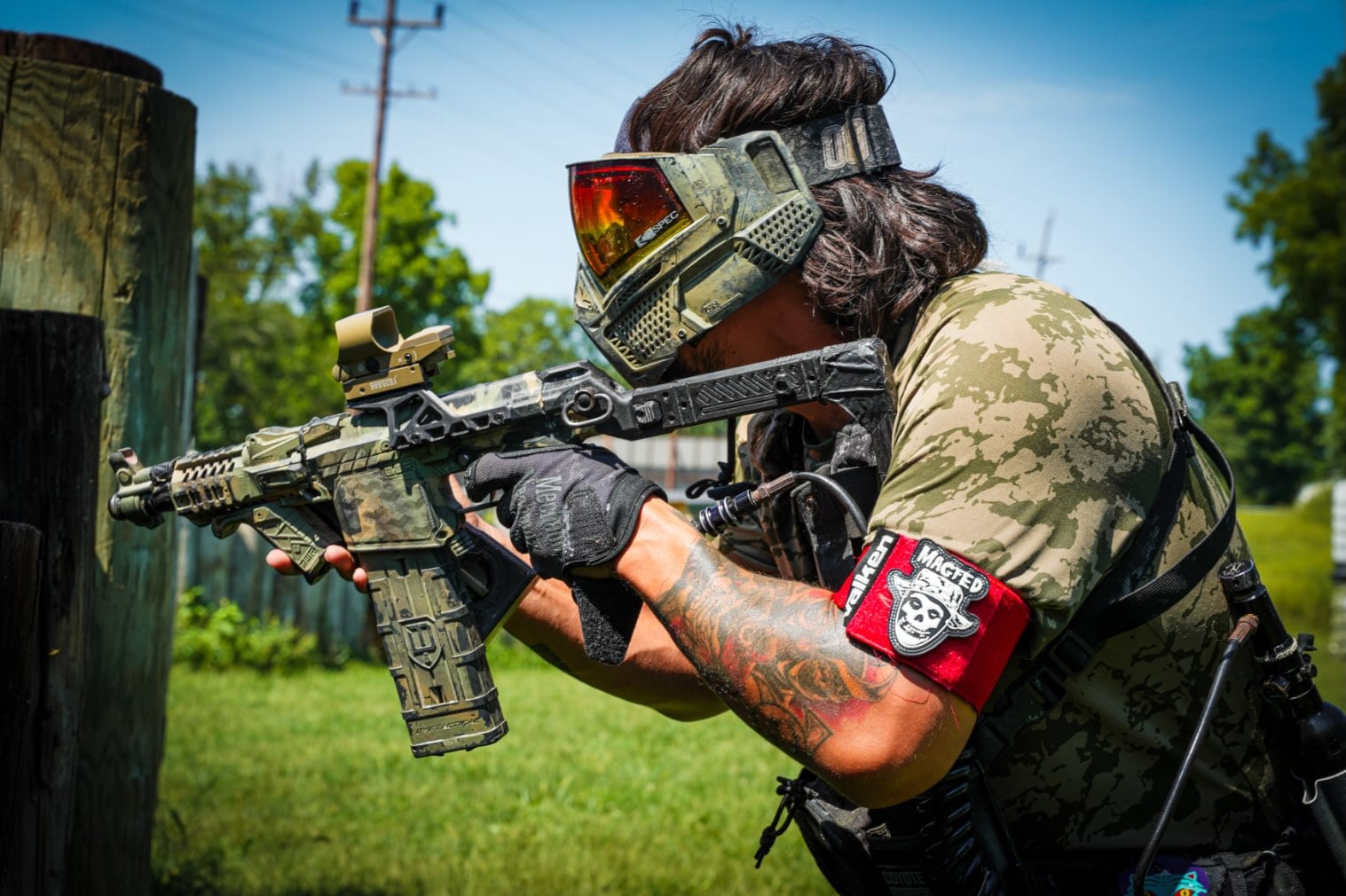 A Coyote Force player aiming a magfed marker from behind cover
