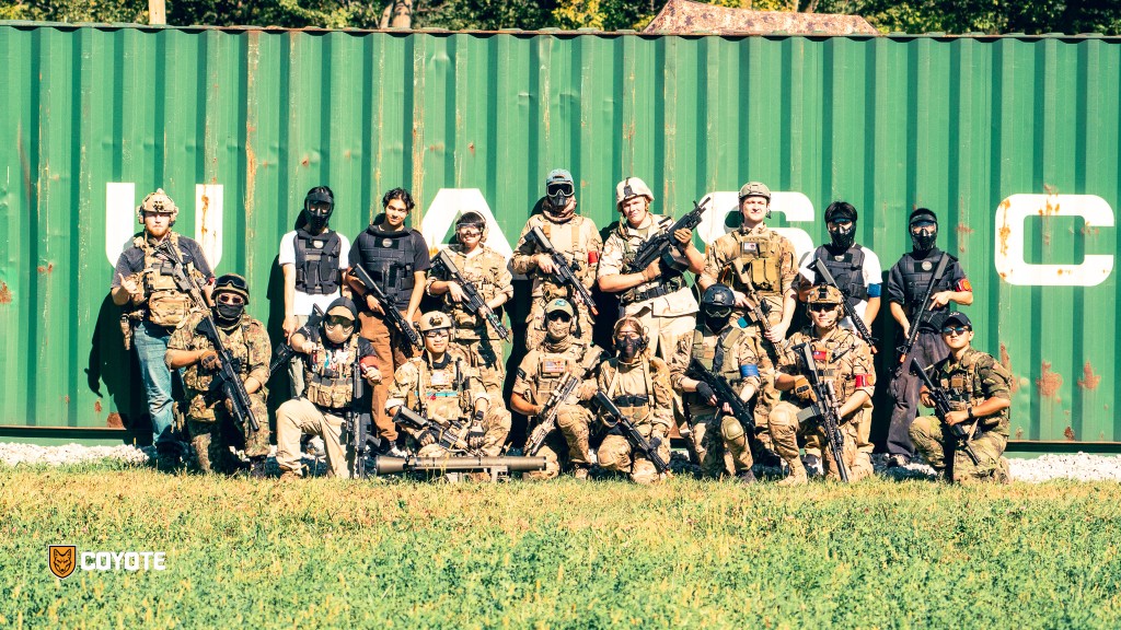 Players gathered on the Battlefield in front of a shipping container at Coyote Field